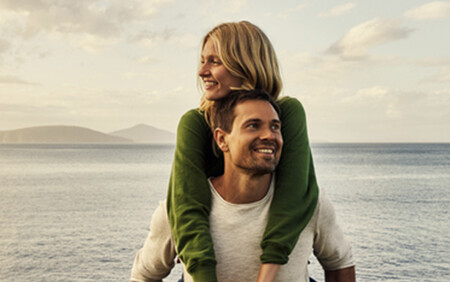 Smiling man and woman by the sea