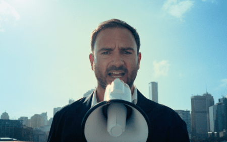 man to camera with megaphone